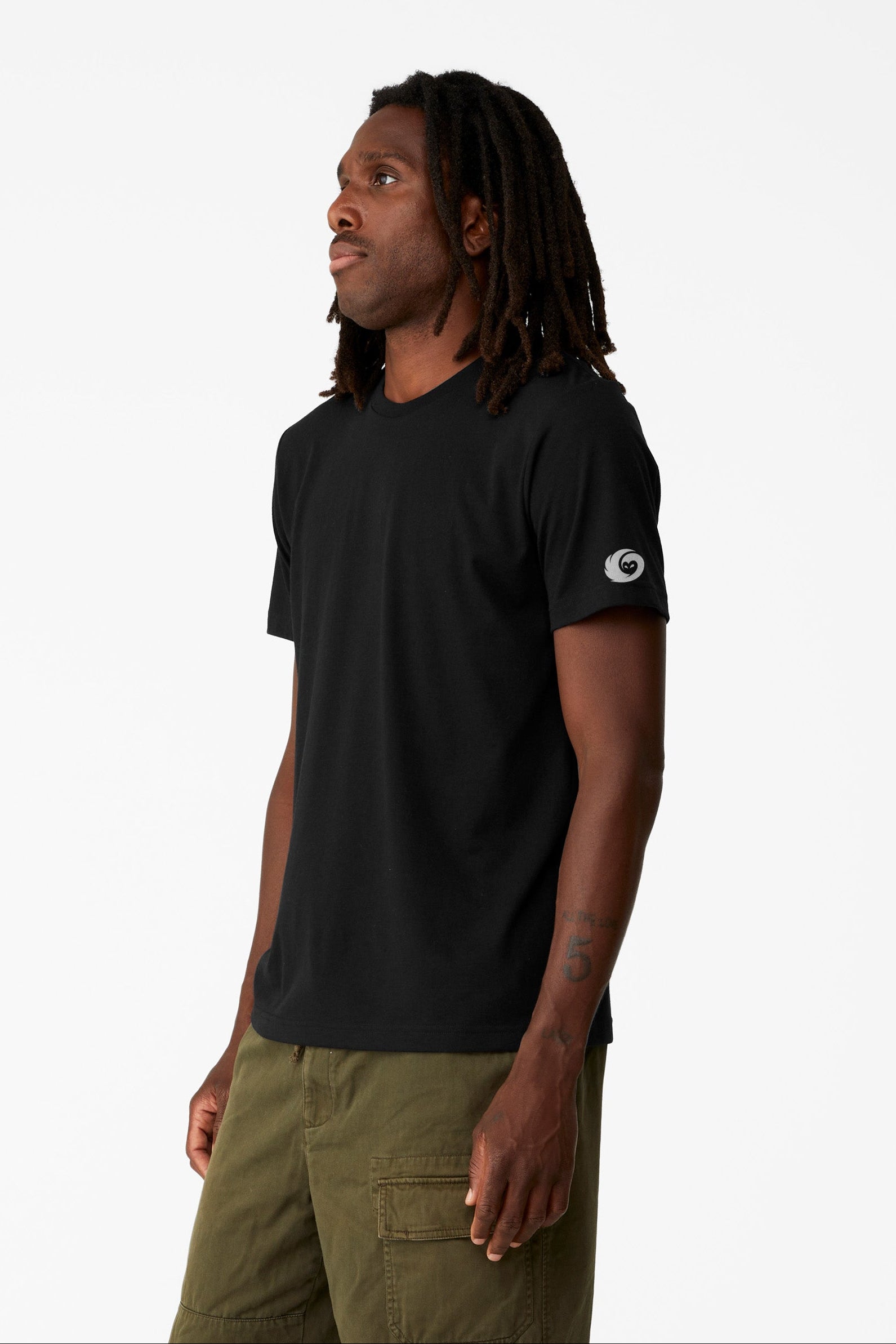 Man wearing a black t-shirt with a white logo on a white background